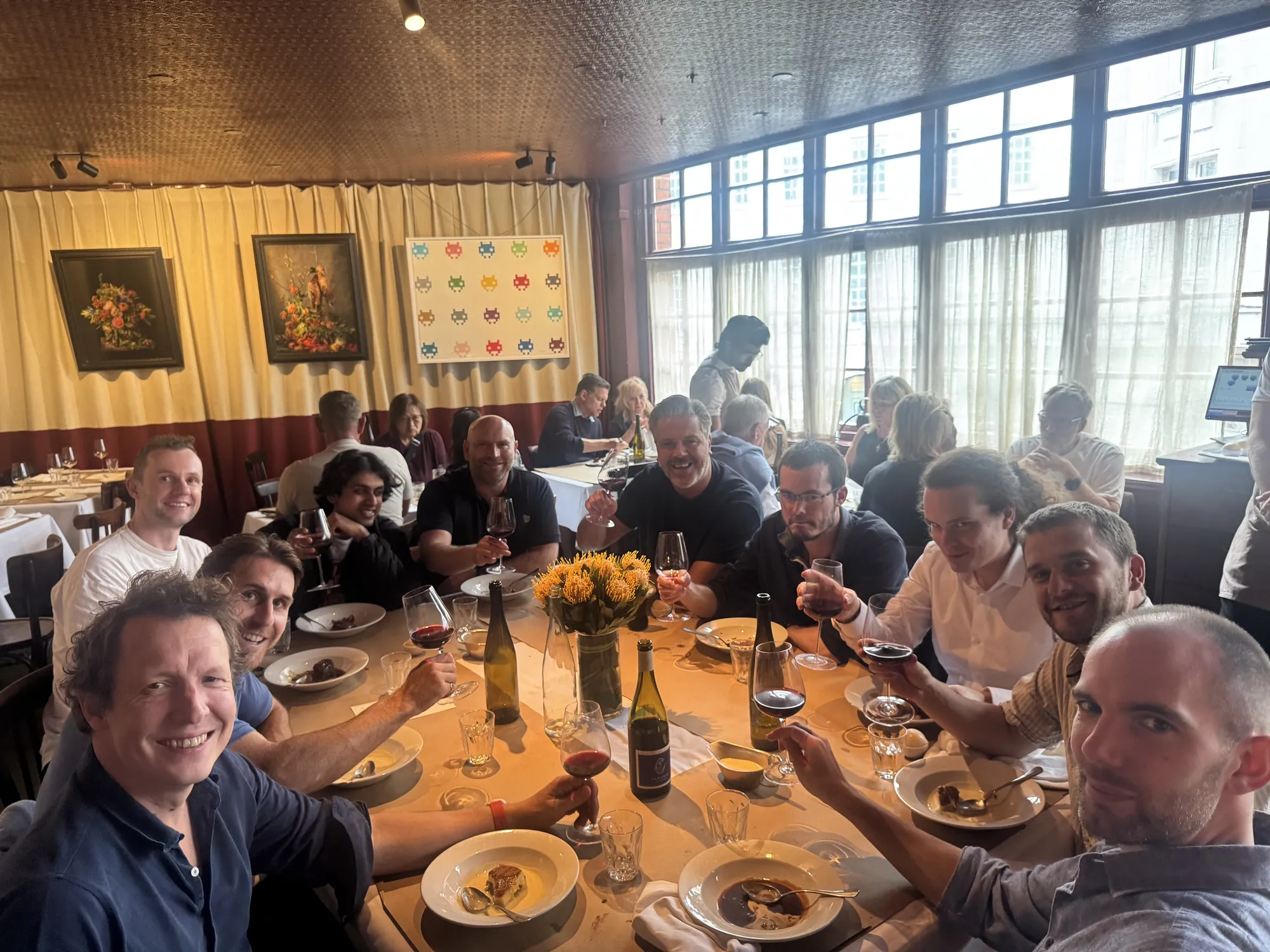 The kennek team raising a glass around one long table at a London restaurant