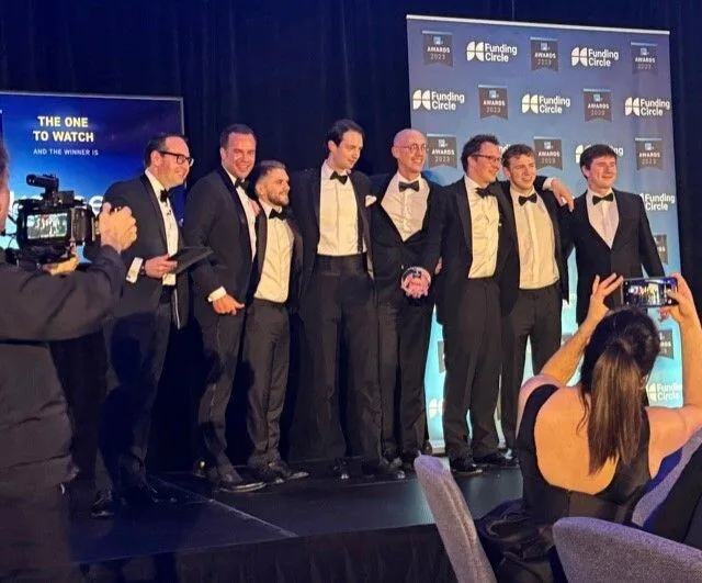 The kennek team on stage collecting The One To Watch award