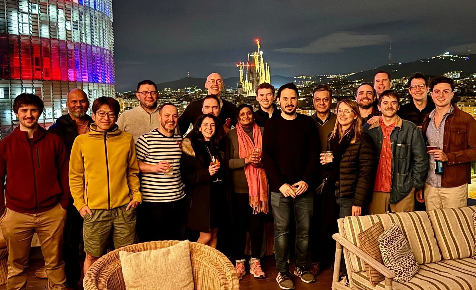 The kennek team on a rooftop in Barcelona at night, the Sagrada Família behind them